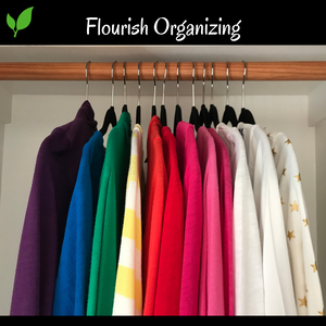 Shot of the closet with hanging sweaters in rainbow order from purple on the left to pink and white on the right. Clothes are hanging on black velvet hangers on a wooden rod in the closet. A heading says Flourish Organizing with the two green leaf logo along a black background heading.
